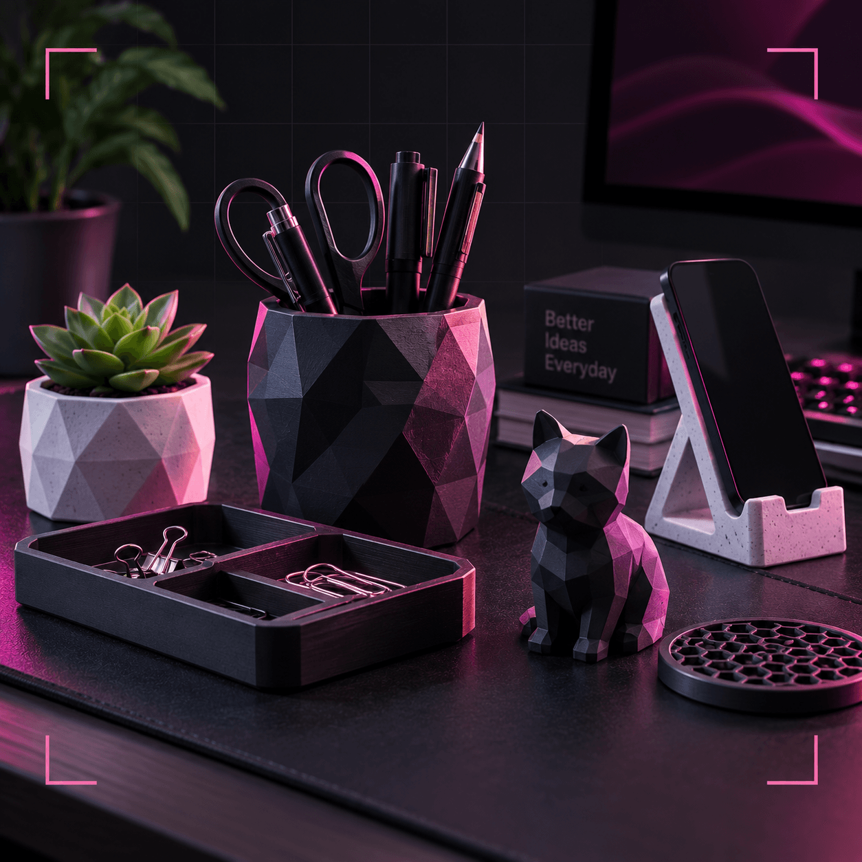 Faceted desk pieces on a dark desk: a pen pot, planter, phone stand, tray and a low-poly cat